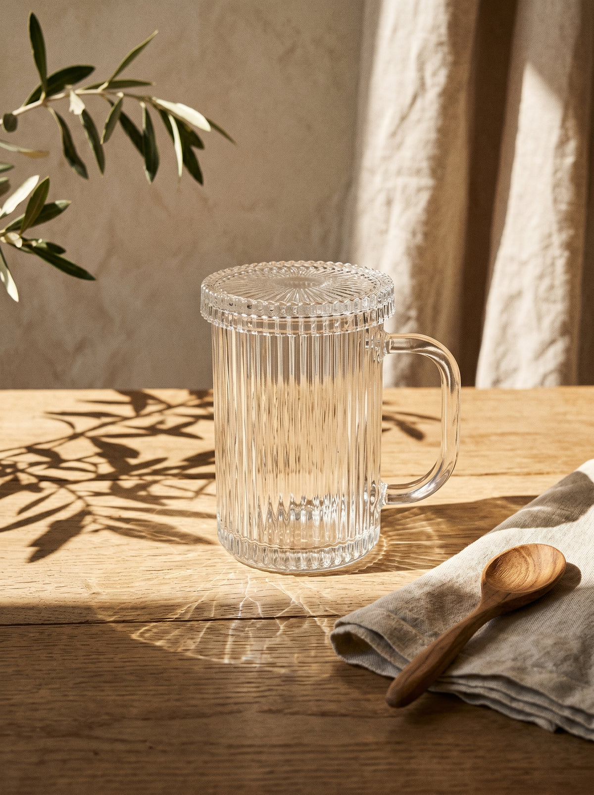 Tasse en verre design avec couvercle, mise en scène sur une table dressée – Maison Azuria